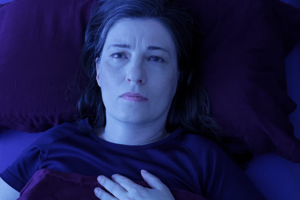 Woman lying in bed Image